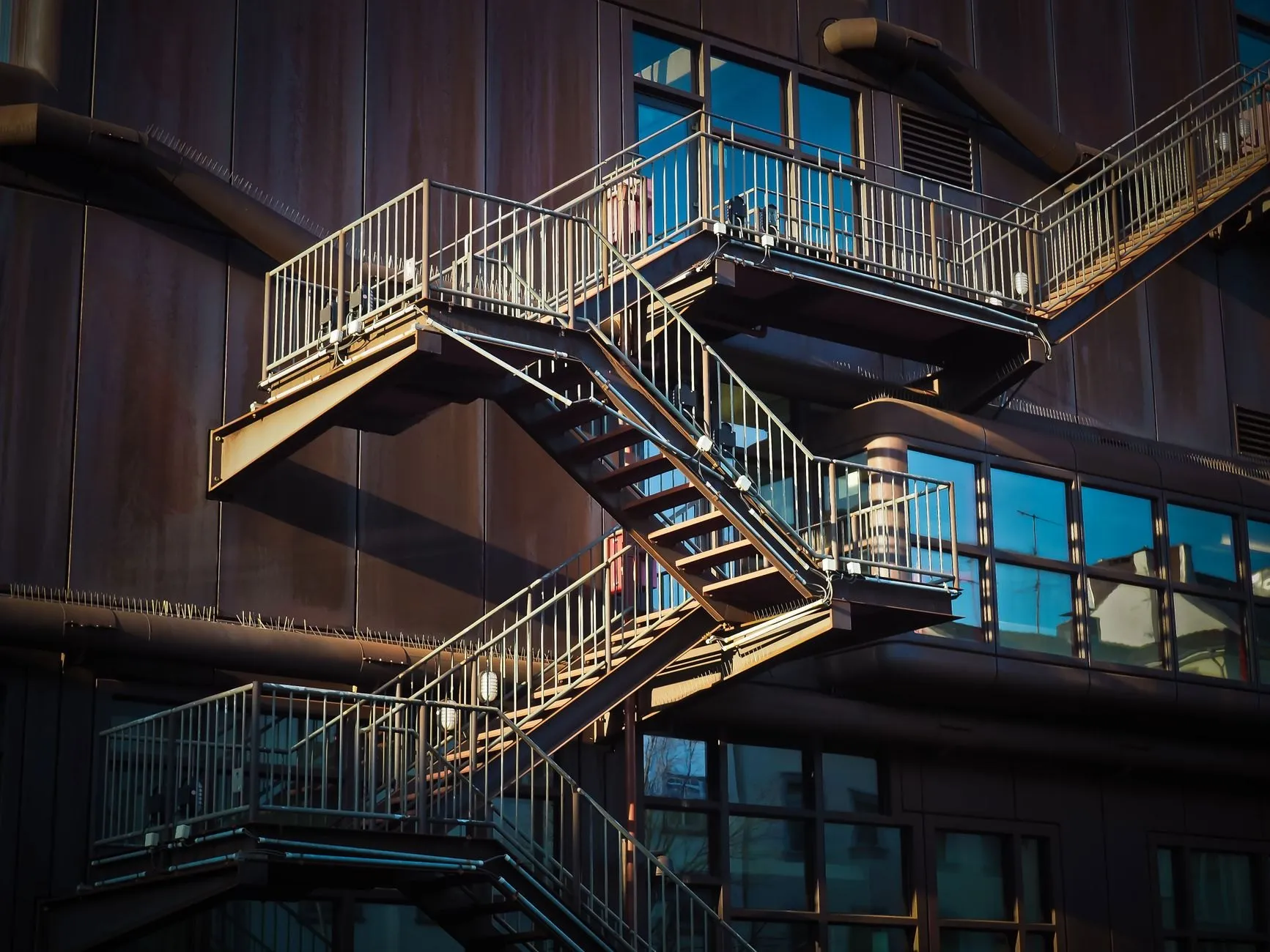 A steel escape stair zig-zagging down the face of a building